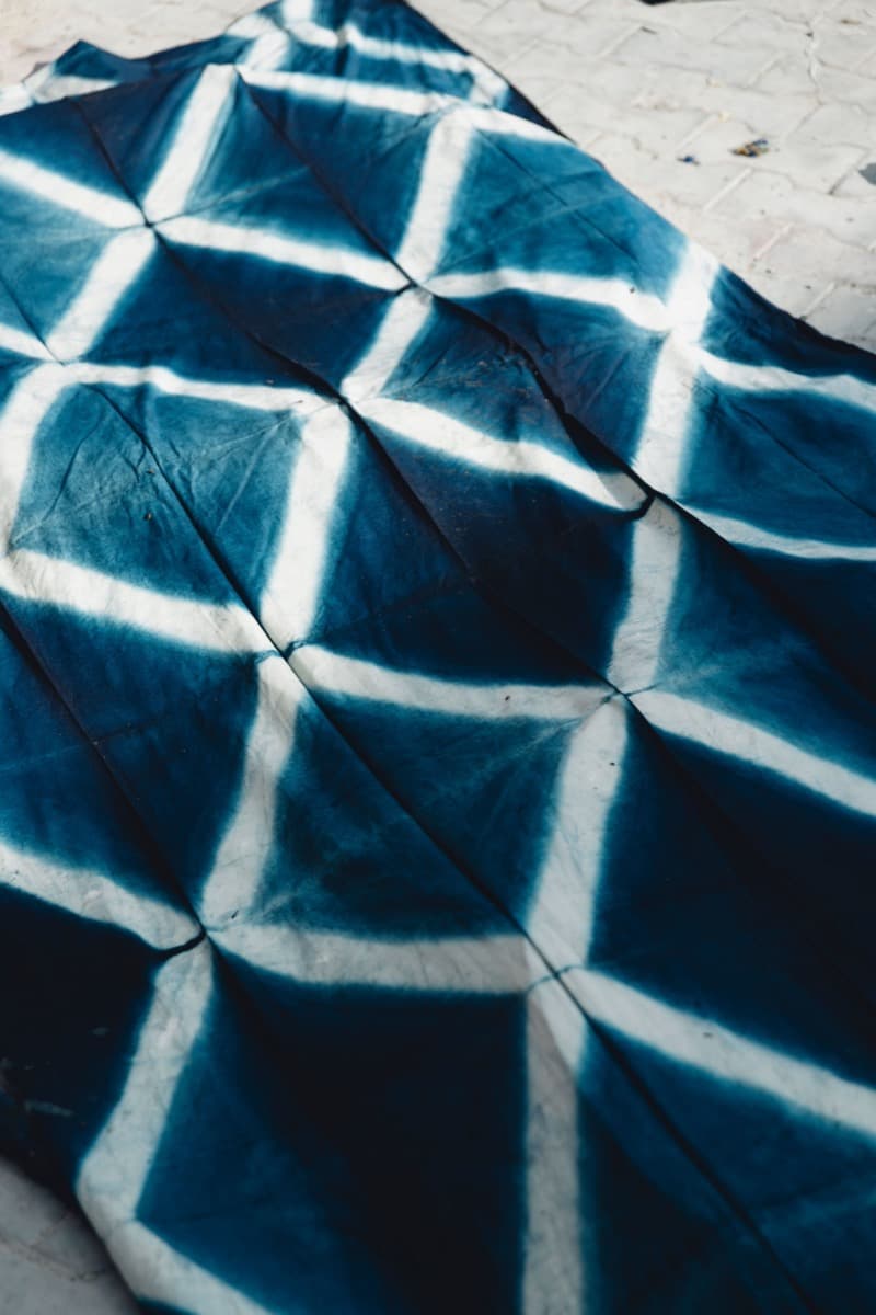 Deep indigo-blue adire fabric with a hand-dyed resist pattern