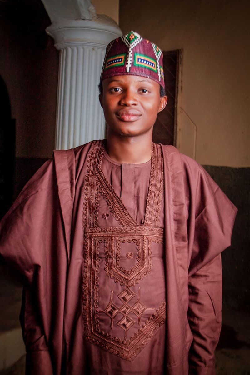 Close-up of dense geometric diamond-motif chest embroidery on a maroon babban riga